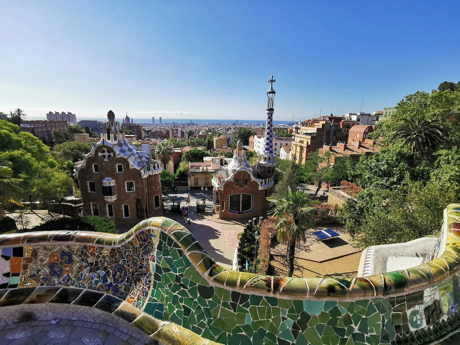 Nature Square at Park Güell with the colourful mosaic bench and views across Barcelona